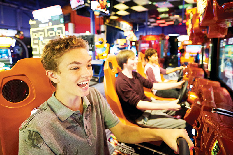Photo of teens playing a driving game
