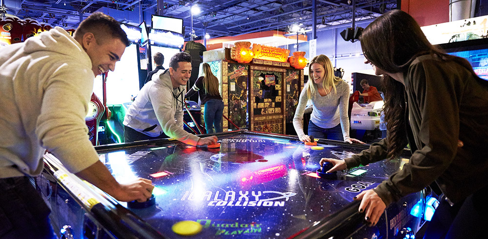Photo of people playing air hockey